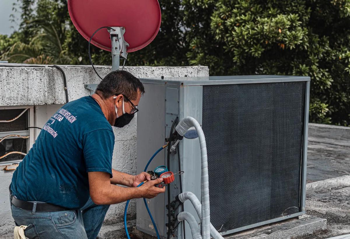HVAC technician servicing an outdoor unit