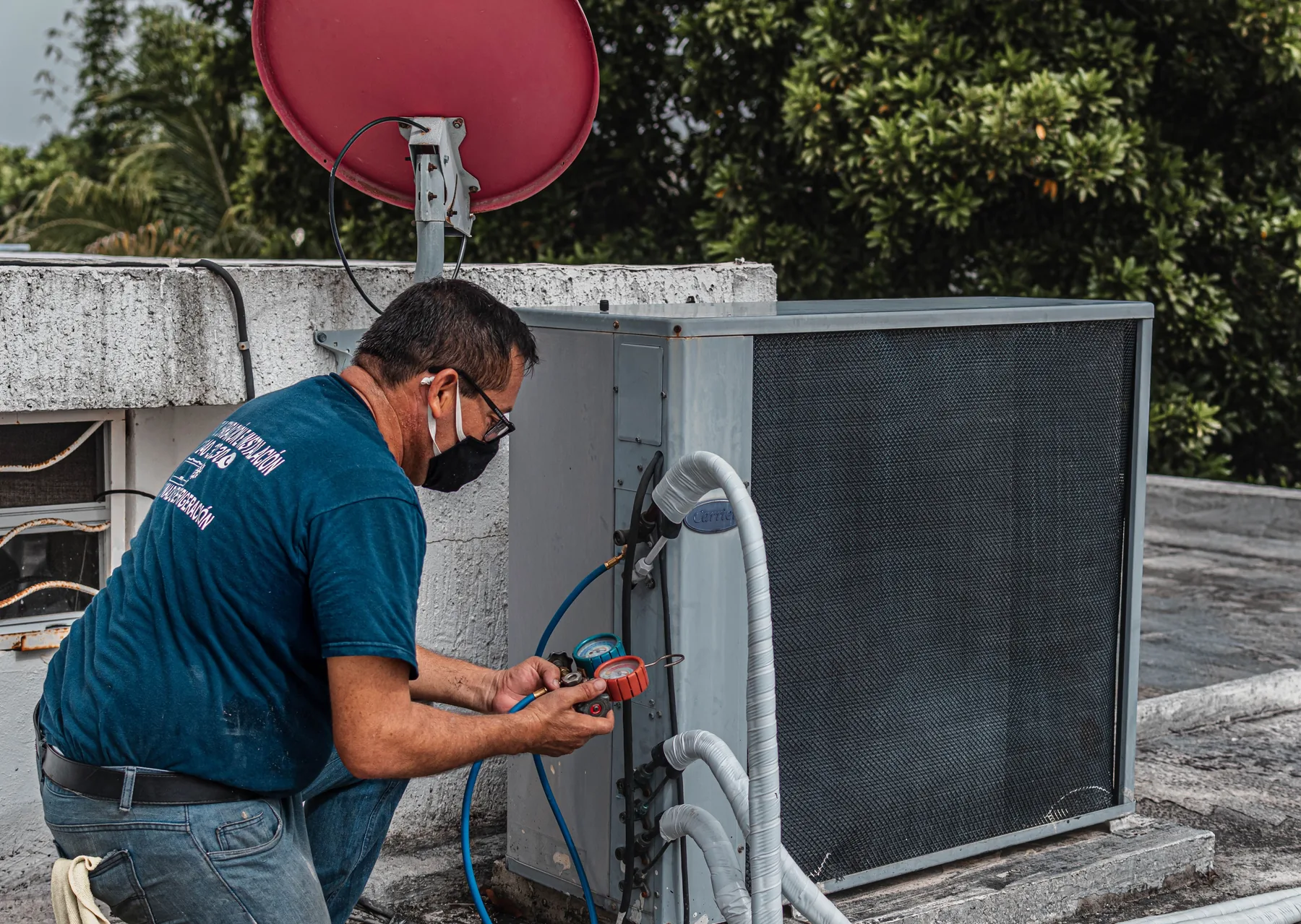 HVAC technician servicing an outdoor comfort system
