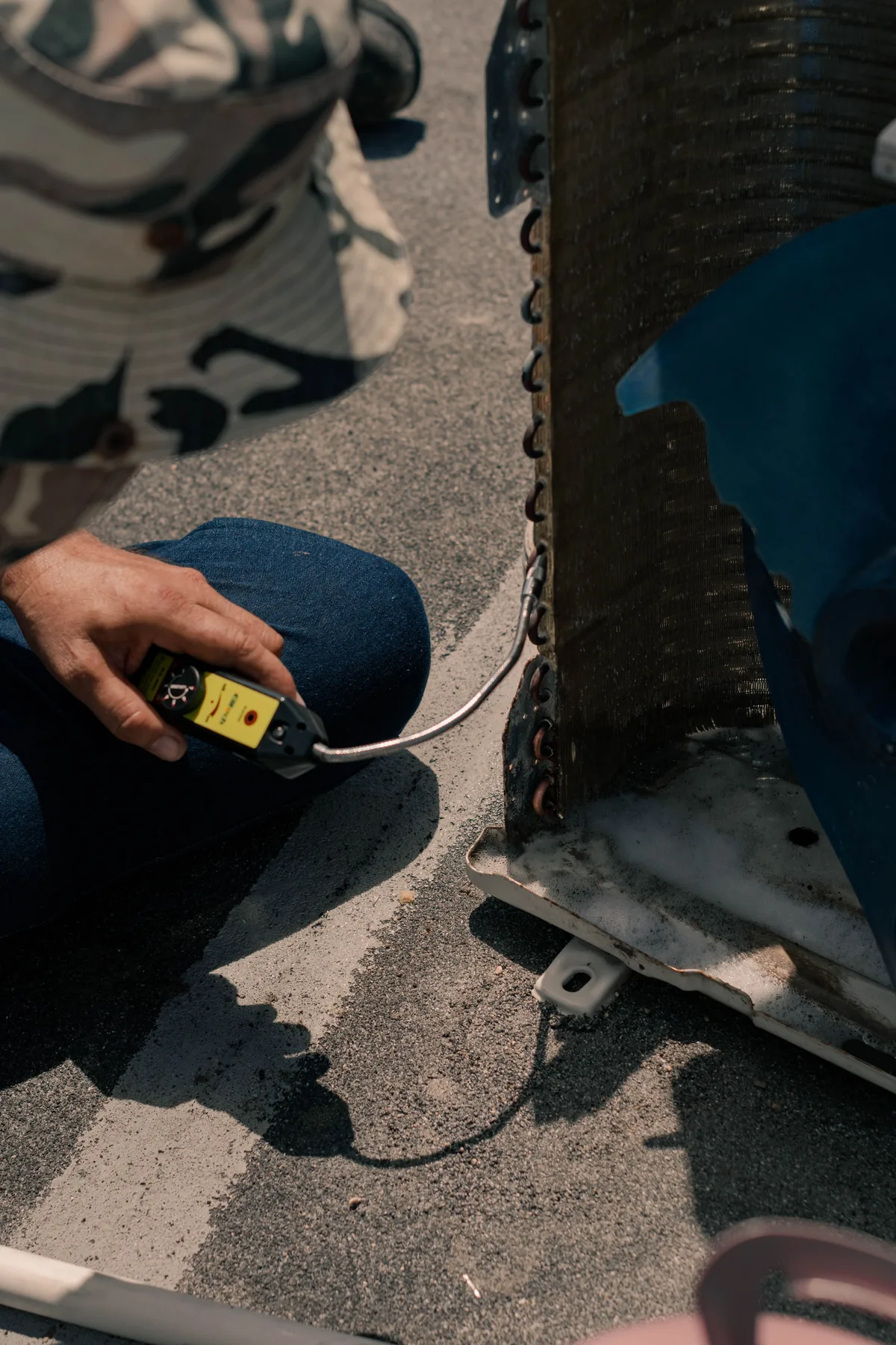 HVAC technician measuring system performance during service