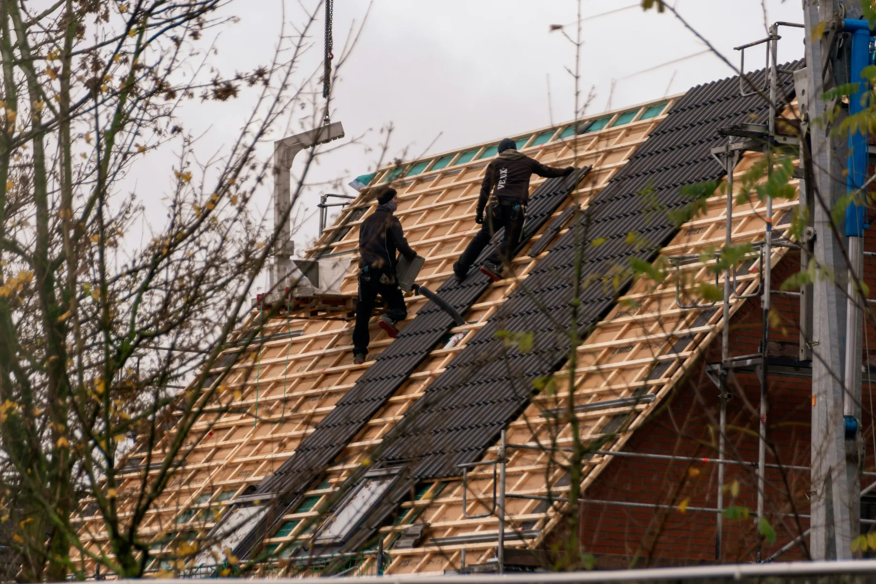 Professional roofing crew installing a residential roof