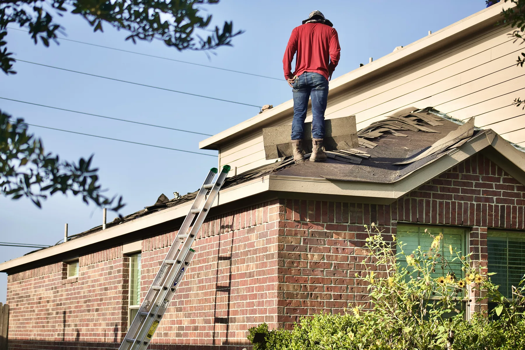 Roofing professionals installing underlayment and shingles